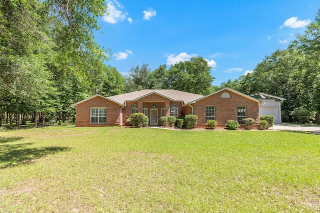 1184 Blackberry Cir, Baker, FL 32531 - ranch-style house with a front yard, brick siding, concrete driveway, and an attached garage