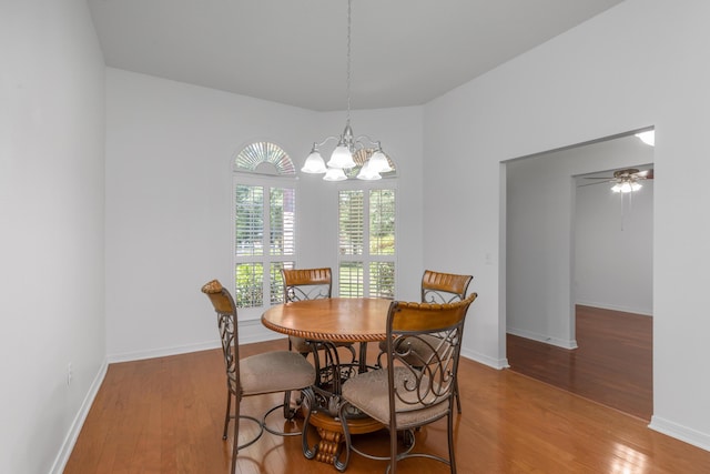 1184 Blackberry Cir, Baker, FL 32531 - dining space with wood finished floors, a chandelier, and baseboards