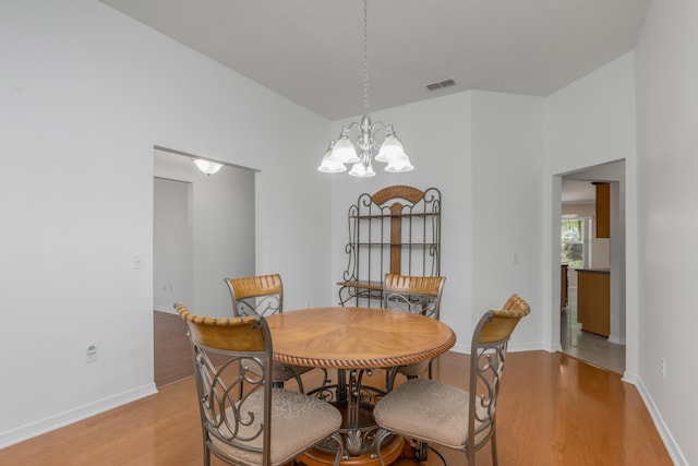 1184 Blackberry Cir, Baker, FL 32531 - dining space with light wood-type flooring, a chandelier, and baseboards