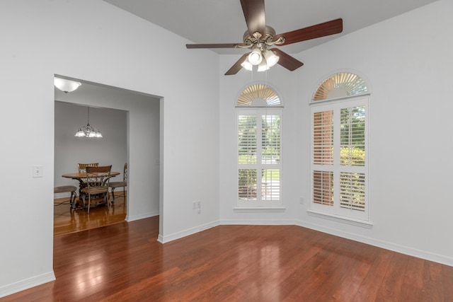 1184 Blackberry Cir, Baker, FL 32531 - empty room with wood-type flooring, ceiling fan, a chandelier, and baseboards