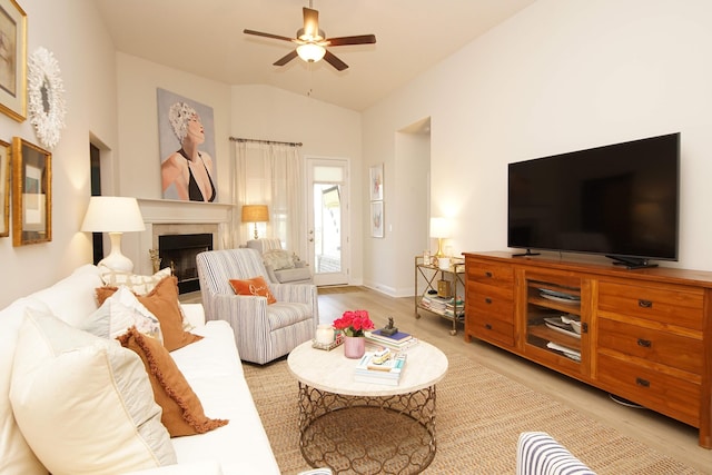 14 Cool Breeze, Freeport, FL 32439 - living area featuring light wood finished floors, ceiling fan, a fireplace, vaulted ceiling, and baseboards