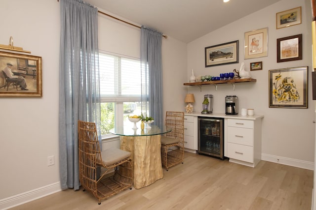 14 Cool Breeze, Freeport, FL 32439 - dining area featuring beverage cooler, a dry bar, light wood-type flooring, lofted ceiling, and baseboards