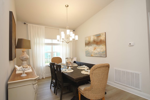 14 Cool Breeze, Freeport, FL 32439 - dining room featuring a chandelier, light wood-style floors, lofted ceiling, and baseboards