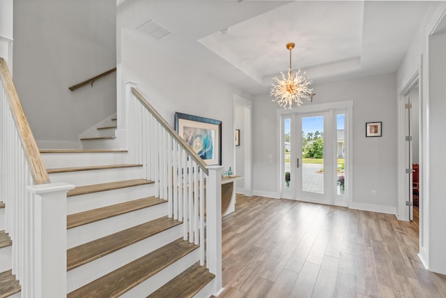 276 W Lafayette Rd, Inlet Beach, FL 32461 - entryway with wood finished floors, a tray ceiling, stairs, a chandelier, and baseboards