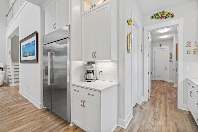 276 W Lafayette Rd, Inlet Beach, FL 32461 - kitchen featuring stainless steel built in fridge, light wood-style flooring, white cabinetry, and light countertops