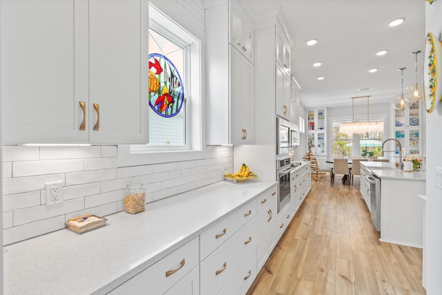 276 W Lafayette Rd, Inlet Beach, FL 32461 - kitchen featuring appliances with stainless steel finishes, white cabinets, light countertops, recessed lighting, and backsplash