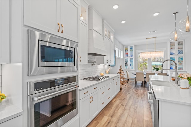 276 W Lafayette Rd, Inlet Beach, FL 32461 - kitchen featuring stainless steel appliances, white cabinets, a sink, light wood-style floors, and a chandelier