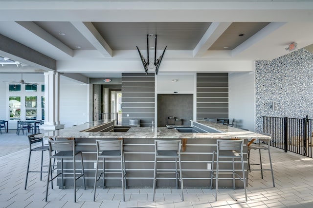 276 W Lafayette Rd, Inlet Beach, FL 32461 - kitchen with beamed ceiling, light stone counters, a kitchen breakfast bar, and ceiling fan