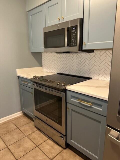 200 Sandestin Ln Apt 401, Miramar Beach, FL 32550 - kitchen with stainless steel appliances, gray cabinets, backsplash, and light countertops