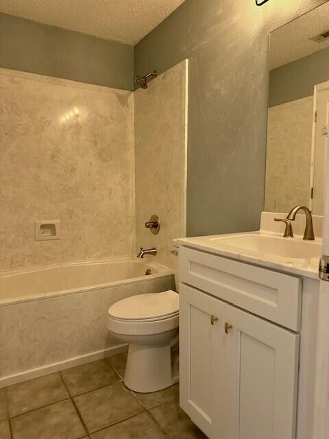 200 Sandestin Ln Apt 401, Miramar Beach, FL 32550 - bathroom featuring a textured ceiling, toilet, vanity,  shower combination, and tile patterned floors