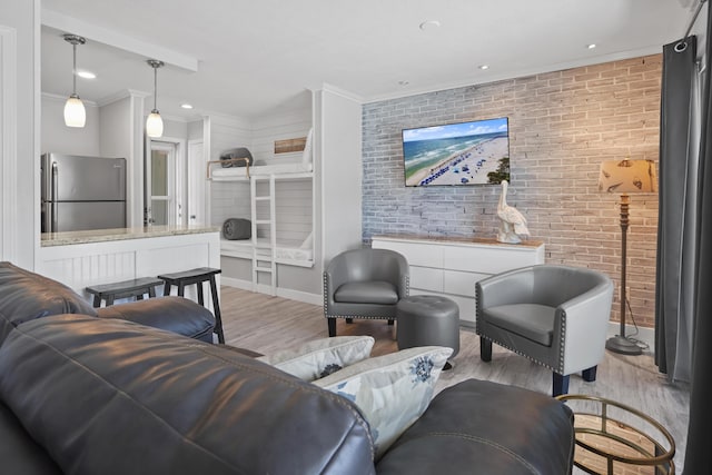134 Damon Cir Unit B, Panama City Beach, FL 32407 - living area with light wood-style flooring, ornamental molding, brick wall, and recessed lighting