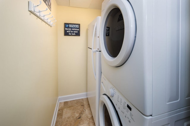 660 Nautilus Ct Unit 1103, Fort Walton Beach, FL 32548 - laundry room with stacked washer / dryer and baseboards
