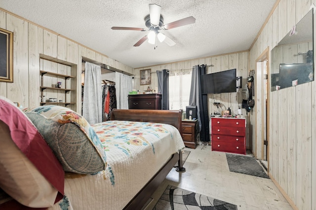 101 SE Elm Ave, Fort Walton Beach, FL 32548 - bedroom with wood walls, a textured ceiling, light flooring, and a ceiling fan