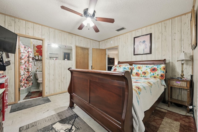 101 SE Elm Ave, Fort Walton Beach, FL 32548 - bedroom featuring ornamental molding, a textured ceiling, wood walls, light flooring, and a ceiling fan