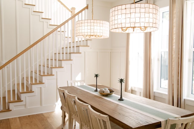 250 Beach Bike Way, Inlet Beach, FL 32461 - dining area with healthy amount of natural light, light wood finished floors, a decorative wall, stairway, and wainscoting