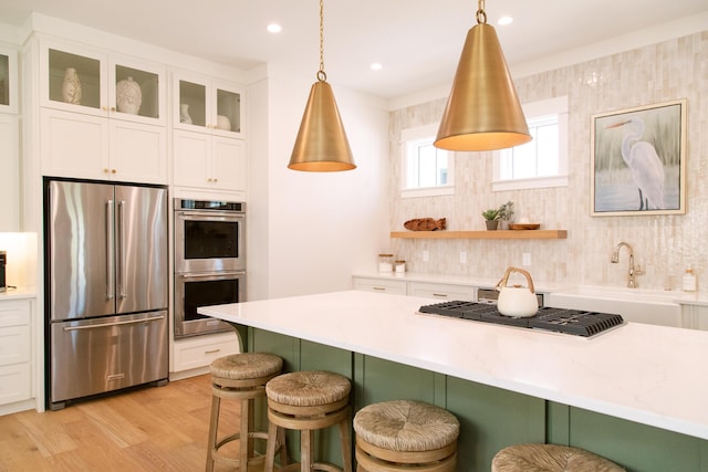 250 Beach Bike Way, Inlet Beach, FL 32461 - kitchen with appliances with stainless steel finishes, a sink, tasteful backsplash, a breakfast bar area, and white cabinets