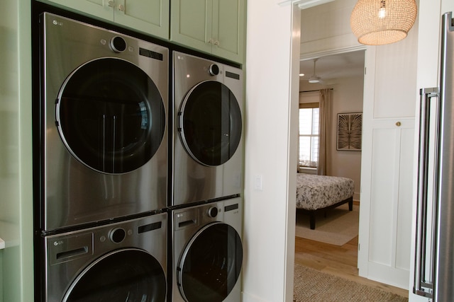 250 Beach Bike Way, Inlet Beach, FL 32461 - washroom featuring stacked washing machine and dryer, cabinet space, wood finished floors, a heating unit, and washer and dryer