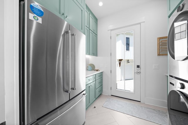 250 Beach Bike Way, Inlet Beach, FL 32461 - kitchen with freestanding refrigerator, stacked washer and clothes dryer, green cabinets, light countertops, and plenty of natural light