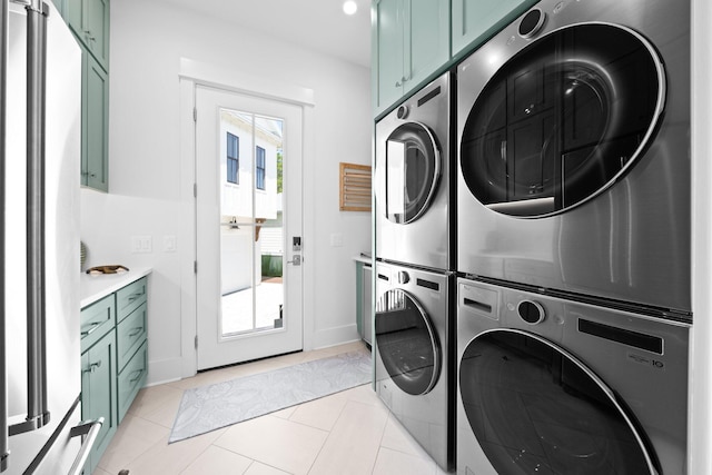 250 Beach Bike Way, Inlet Beach, FL 32461 - laundry room with stacked washing machine and dryer, cabinet space, baseboards, and light tile patterned flooring
