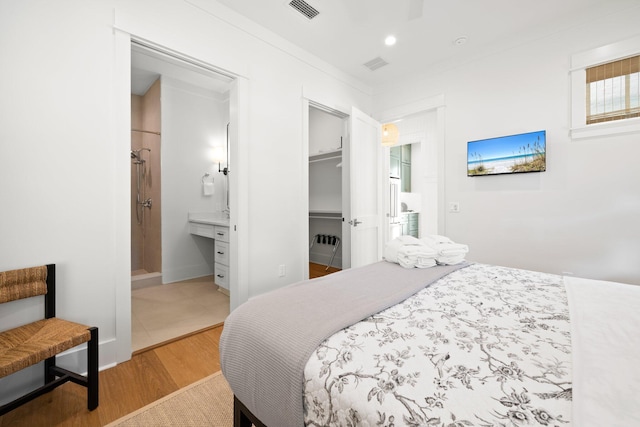 250 Beach Bike Way, Inlet Beach, FL 32461 - bedroom with wood finished floors, a walk in closet, connected bathroom, a closet, and recessed lighting