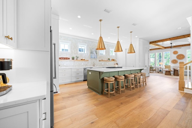 250 Beach Bike Way, Inlet Beach, FL 32461 - kitchen with a breakfast bar area, stainless steel appliances, light wood-style flooring, a kitchen island, and light countertops