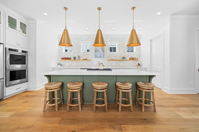 250 Beach Bike Way, Inlet Beach, FL 32461 - kitchen with double oven, light countertops, a center island, green cabinets, and recessed lighting