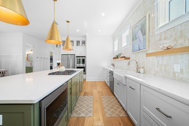 250 Beach Bike Way, Inlet Beach, FL 32461 - kitchen featuring stainless steel appliances, light wood-type flooring, a sink, open shelves, and a kitchen island