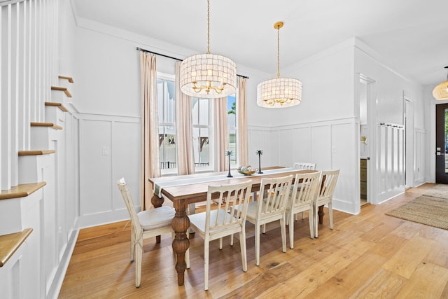 250 Beach Bike Way, Inlet Beach, FL 32461 - dining room with a decorative wall, a chandelier, healthy amount of natural light, light wood-style flooring, and wainscoting