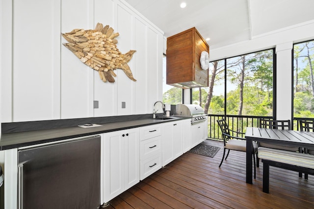 250 Beach Bike Way, Inlet Beach, FL 32461 - kitchen with dark countertops, a sink, white cabinets, dark wood-style flooring, and fridge