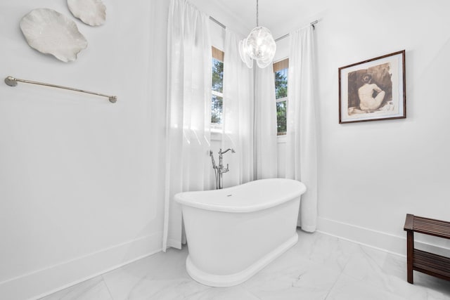 250 Beach Bike Way, Inlet Beach, FL 32461 - bathroom featuring marble look tile flooring, a chandelier, a soaking tub, and baseboards