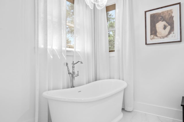 250 Beach Bike Way, Inlet Beach, FL 32461 - bathroom with a soaking tub, marble finish floors, and baseboards