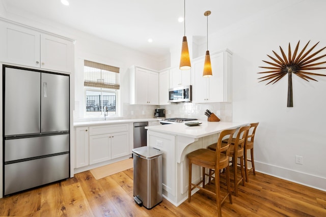 250 Beach Bike Way, Inlet Beach, FL 32461 - kitchen featuring appliances with stainless steel finishes, a peninsula, decorative backsplash, white cabinetry, and recessed lighting