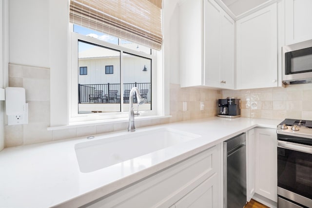 250 Beach Bike Way, Inlet Beach, FL 32461 - kitchen featuring stainless steel appliances, a sink, white cabinets, and decorative backsplash