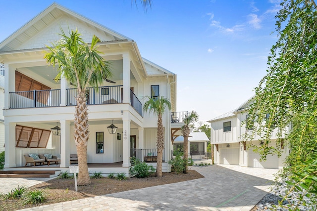 250 Beach Bike Way, Inlet Beach, FL 32461 - view of front of home with a balcony, covered porch, a garage, decorative driveway, and board and batten siding