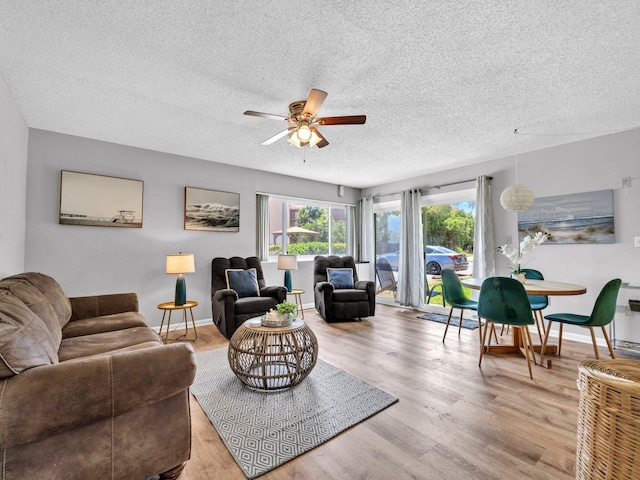 107 Surf Song Ln Unit A1, Miramar Beach, FL 32550 - living area with a ceiling fan, light wood-style floors, a textured ceiling, and baseboards