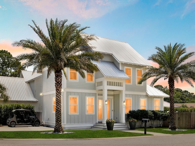 14 Bayshore Pines Ct, Miramar Beach, FL 32550 - view of front of house featuring board and batten siding, driveway, and metal roof