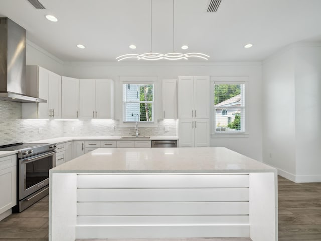 14 Bayshore Pines Ct, Miramar Beach, FL 32550 - kitchen with wall chimney range hood, stainless steel appliances, healthy amount of natural light, ornamental molding, and decorative backsplash