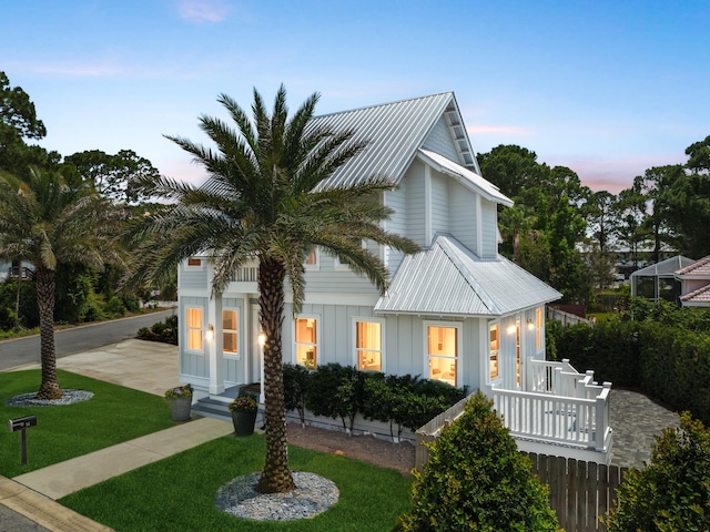 14 Bayshore Pines Ct, Miramar Beach, FL 32550 - view of front of property featuring board and batten siding, a yard, and metal roof
