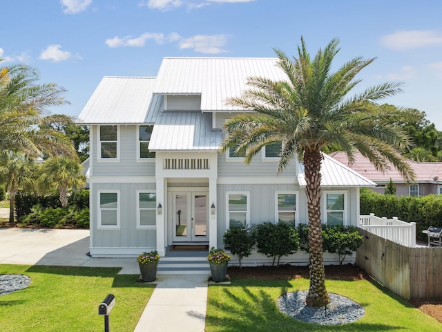 14 Bayshore Pines Ct, Miramar Beach, FL 32550 - view of front of house with board and batten siding, french doors, and metal roof