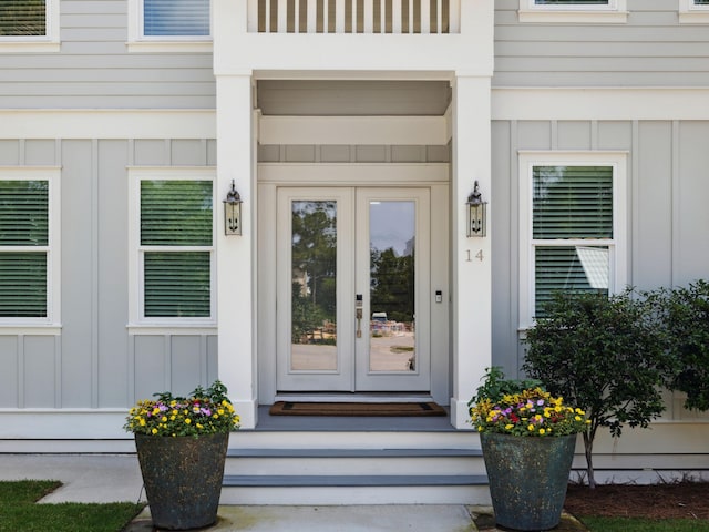 14 Bayshore Pines Ct, Miramar Beach, FL 32550 - view of exterior entry featuring french doors and board and batten siding