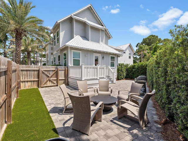 14 Bayshore Pines Ct, Miramar Beach, FL 32550 - view of patio / terrace featuring a gate, a fire pit, and grilling area