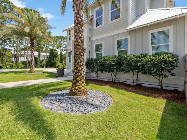 14 Bayshore Pines Ct, Miramar Beach, FL 32550 - view of property exterior with board and batten siding and a yard