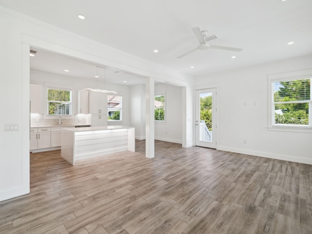 14 Bayshore Pines Ct, Miramar Beach, FL 32550 - unfurnished living room with a sink, light wood-style flooring, plenty of natural light, and recessed lighting