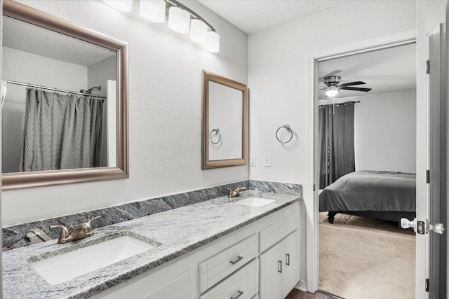7319 Gordon Evans Rd, Navarre, FL 32566 - full bathroom featuring double vanity, a textured ceiling, a ceiling fan, and connected bathroom