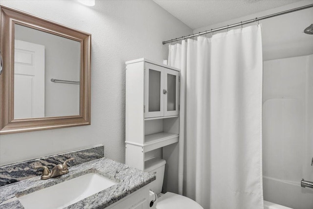 7319 Gordon Evans Rd, Navarre, FL 32566 - full bathroom with vanity, toilet, and a textured ceiling