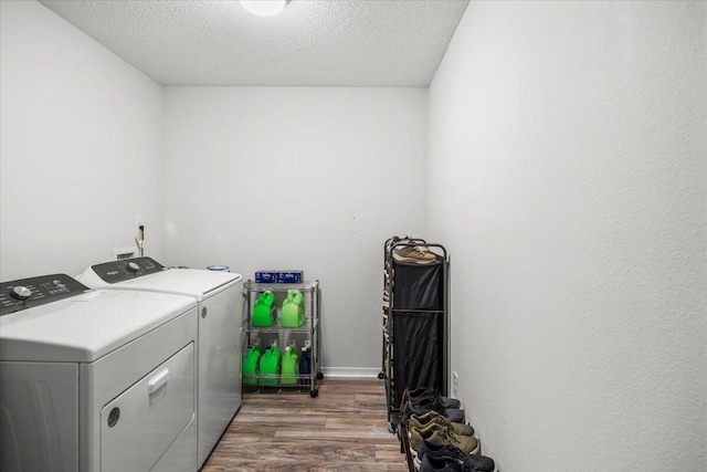 7319 Gordon Evans Rd, Navarre, FL 32566 - laundry area with separate washer and dryer, wood finished floors, and a textured ceiling