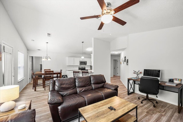 7319 Gordon Evans Rd, Navarre, FL 32566 - living area featuring light wood-style flooring, ceiling fan, a desk, vaulted ceiling, and baseboards