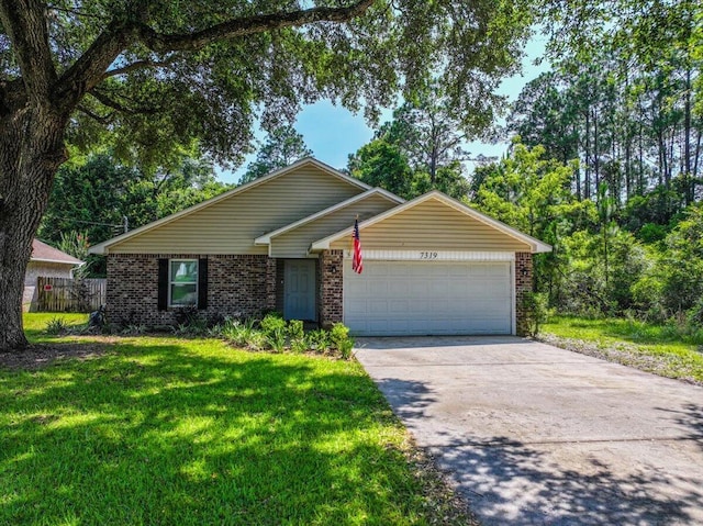 7319 Gordon Evans Rd, Navarre, FL 32566 - view of front of property featuring brick siding, an attached garage, and concrete driveway