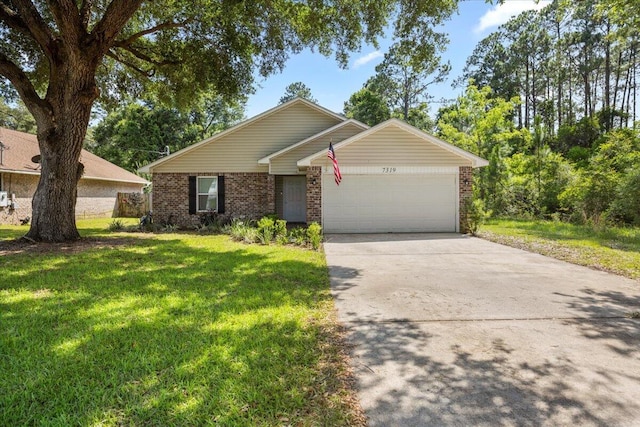 7319 Gordon Evans Rd, Navarre, FL 32566 - view of front of house featuring brick siding, a garage, a front yard, and concrete driveway