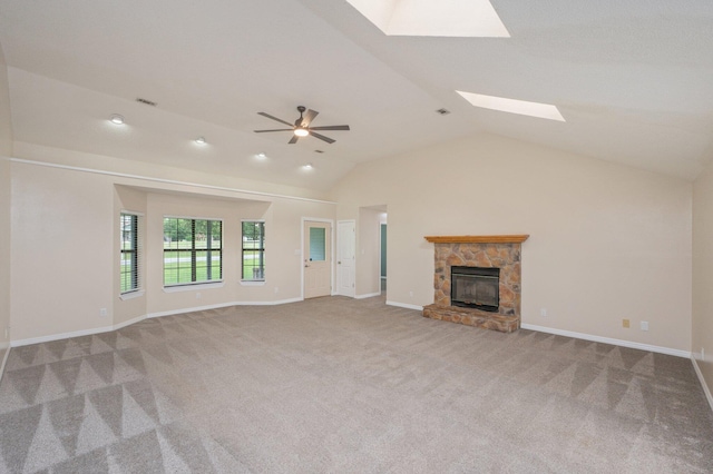 5903 Jack Stokes Rd, Baker, FL 32531 - unfurnished living room featuring a skylight, carpet, a stone fireplace, and lofted ceiling